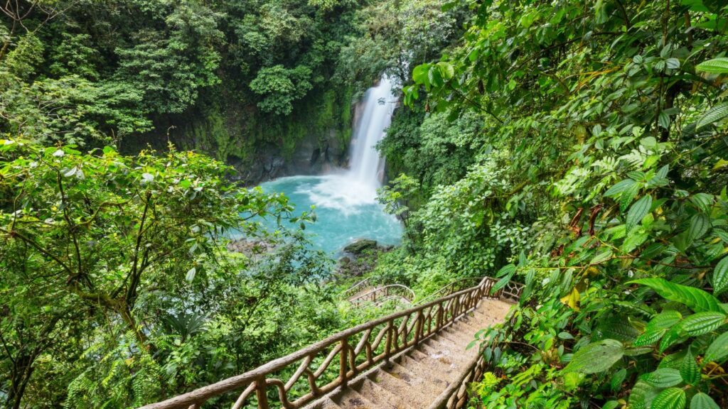 Majestic waterfall cascading through lush greenery in Costa Rican jungle