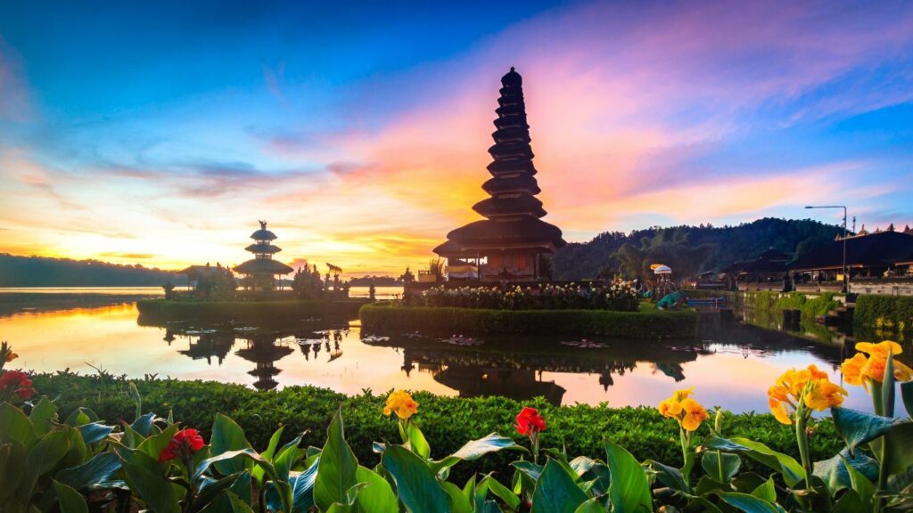 Witness the breathtaking sunrise at Bali's temple amidst water, flowers, and tranquil ambiance